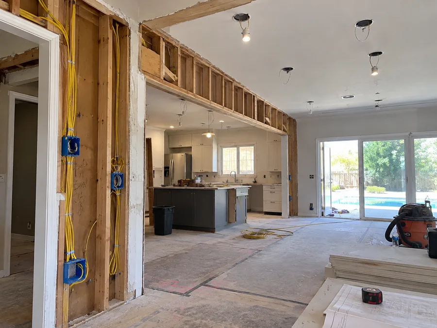 Residential kitchen remodel during electrical rough-in with new wiring and electrical boxes visible